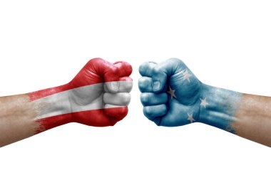 Two hands punch to each others on white background. Country flags painted fists, conflict crisis concept between austria and micronesia