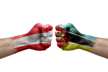Two hands punch to each others on white background. Country flags painted fists, conflict crisis concept between austria and mozambique