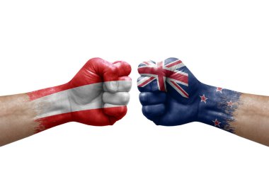 Two hands punch to each others on white background. Country flags painted fists, conflict crisis concept between austria and new zealand