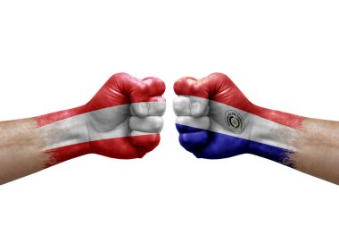 Two hands punch to each others on white background. Country flags painted fists, conflict crisis concept between austria and paraguay