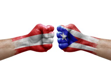 Two hands punch to each others on white background. Country flags painted fists, conflict crisis concept between austria and puerto rico