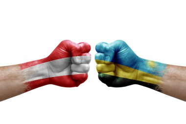 Two hands punch to each others on white background. Country flags painted fists, conflict crisis concept between austria and rwanda