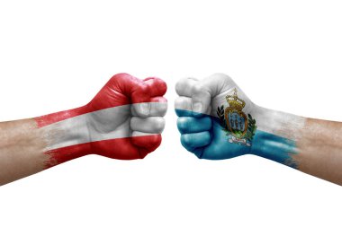 Two hands punch to each others on white background. Country flags painted fists, conflict crisis concept between austria and san marino