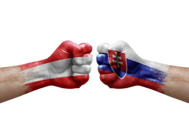 Two hands punch to each others on white background. Country flags painted fists, conflict crisis concept between austria and slovakia