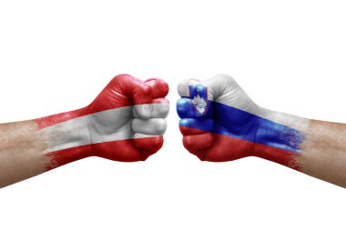 Two hands punch to each others on white background. Country flags painted fists, conflict crisis concept between austria and slovenia