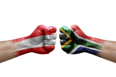 Two hands punch to each others on white background. Country flags painted fists, conflict crisis concept between austria and south africa