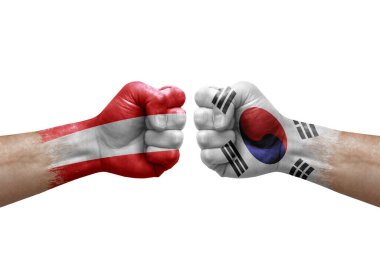 Two hands punch to each others on white background. Country flags painted fists, conflict crisis concept between austria and south korea