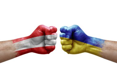 Two hands punch to each others on white background. Country flags painted fists, conflict crisis concept between austria and ukraine
