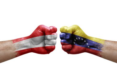 Two hands punch to each others on white background. Country flags painted fists, conflict crisis concept between austria and venezuela