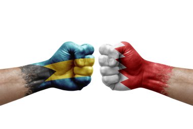 Two hands punch to each others on white background. Country flags painted fists, conflict crisis concept between bahamas and bahrain