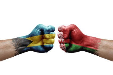 Two hands punch to each others on white background. Country flags painted fists, conflict crisis concept between bahamas and belarus