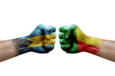 Two hands punch to each others on white background. Country flags painted fists, conflict crisis concept between bahamas and benin