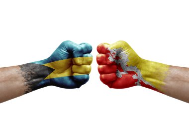 Two hands punch to each others on white background. Country flags painted fists, conflict crisis concept between bahamas and bhutan