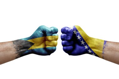 Two hands punch to each others on white background. Country flags painted fists, conflict crisis concept between bahamas and bosnia