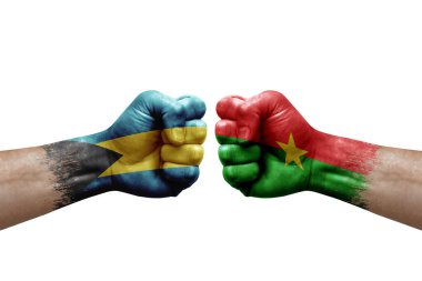 Two hands punch to each others on white background. Country flags painted fists, conflict crisis concept between bahamas and burkina faso