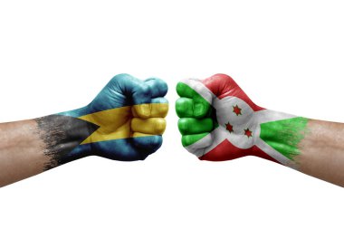 Two hands punch to each others on white background. Country flags painted fists, conflict crisis concept between bahamas and burundi