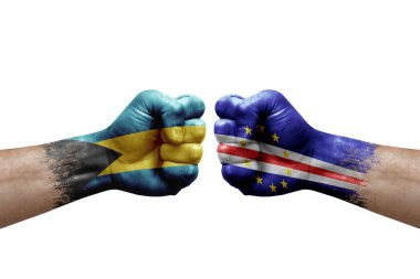 Two hands punch to each others on white background. Country flags painted fists, conflict crisis concept between bahamas and cape verde