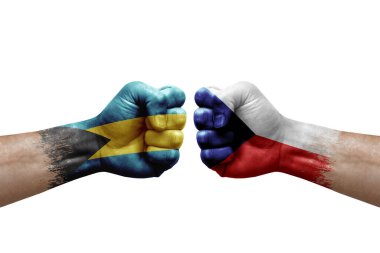 Two hands punch to each others on white background. Country flags painted fists, conflict crisis concept between bahamas and czechia