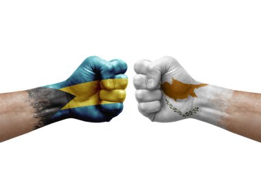 Two hands punch to each others on white background. Country flags painted fists, conflict crisis concept between bahamas and cyprus