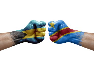 Two hands punch to each others on white background. Country flags painted fists, conflict crisis concept between bahamas and dr congo