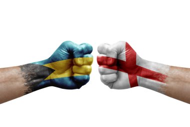 Two hands punch to each others on white background. Country flags painted fists, conflict crisis concept between bahamas and england