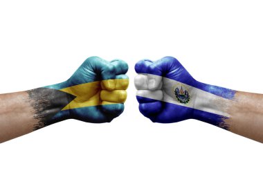Two hands punch to each others on white background. Country flags painted fists, conflict crisis concept between bahamas and el salvador