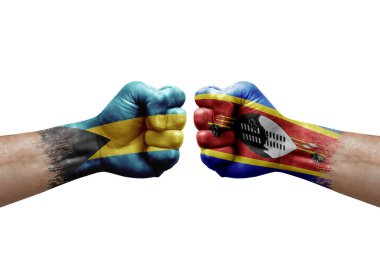 Two hands punch to each others on white background. Country flags painted fists, conflict crisis concept between bahamas and eswatini