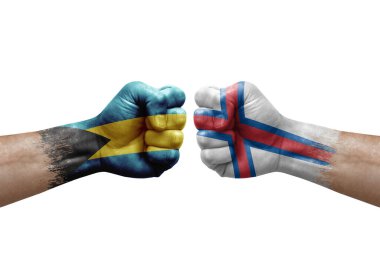 Two hands punch to each others on white background. Country flags painted fists, conflict crisis concept between bahamas and faroe islands