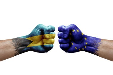 Two hands punch to each others on white background. Country flags painted fists, conflict crisis concept between bahamas and european union