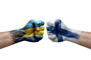 Two hands punch to each others on white background. Country flags painted fists, conflict crisis concept between bahamas and finland