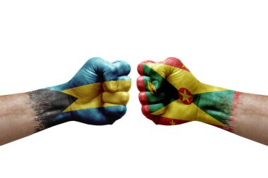Two hands punch to each others on white background. Country flags painted fists, conflict crisis concept between bahamas and grenada