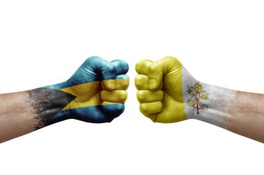 Two hands punch to each others on white background. Country flags painted fists, conflict crisis concept between bahamas and holy see