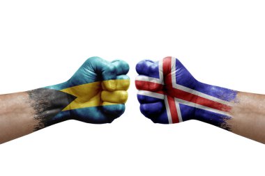 Two hands punch to each others on white background. Country flags painted fists, conflict crisis concept between bahamas and iceland