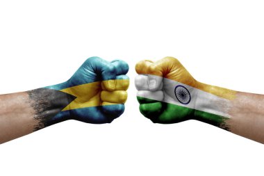 Two hands punch to each others on white background. Country flags painted fists, conflict crisis concept between bahamas and india