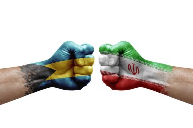 Two hands punch to each others on white background. Country flags painted fists, conflict crisis concept between bahamas and iran