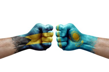 Two hands punch to each others on white background. Country flags painted fists, conflict crisis concept between bahamas and kazakhstan