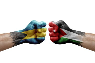 Two hands punch to each others on white background. Country flags painted fists, conflict crisis concept between bahamas and jordan
