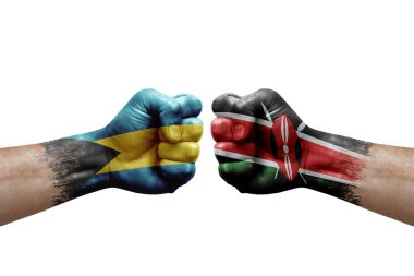 Two hands punch to each others on white background. Country flags painted fists, conflict crisis concept between bahamas and kenya