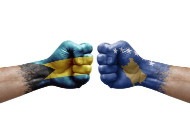 Two hands punch to each others on white background. Country flags painted fists, conflict crisis concept between bahamas and kosovo