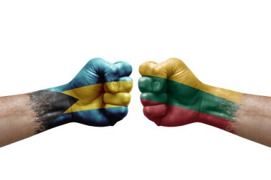 Two hands punch to each others on white background. Country flags painted fists, conflict crisis concept between bahamas and lithuania