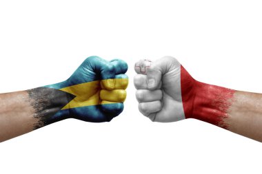 Two hands punch to each others on white background. Country flags painted fists, conflict crisis concept between bahamas and malta