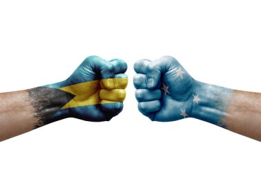 Two hands punch to each others on white background. Country flags painted fists, conflict crisis concept between bahamas and micronesia
