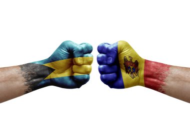 Two hands punch to each others on white background. Country flags painted fists, conflict crisis concept between bahamas and moldova