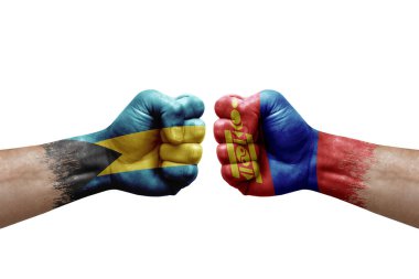 Two hands punch to each others on white background. Country flags painted fists, conflict crisis concept between bahamas and mongolia