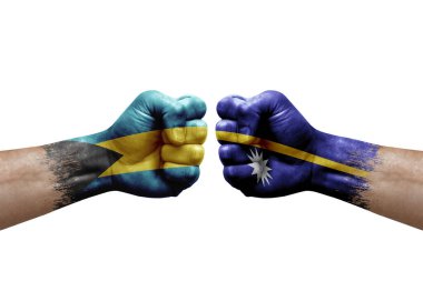 Two hands punch to each others on white background. Country flags painted fists, conflict crisis concept between bahamas and nauru