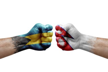 Two hands punch to each others on white background. Country flags painted fists, conflict crisis concept between bahamas and nepal