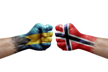 Two hands punch to each others on white background. Country flags painted fists, conflict crisis concept between bahamas and norway