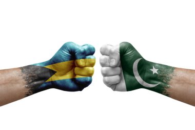 Two hands punch to each others on white background. Country flags painted fists, conflict crisis concept between bahamas and pakistan