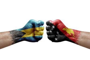 Two hands punch to each others on white background. Country flags painted fists, conflict crisis concept between bahamas and papua new guinea