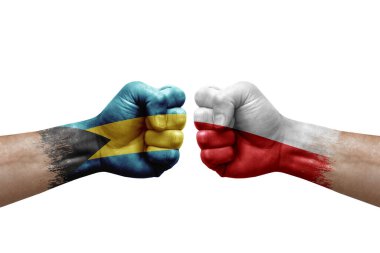 Two hands punch to each others on white background. Country flags painted fists, conflict crisis concept between bahamas and poland